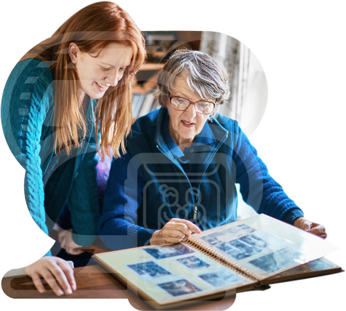 Two people looking through a family photo album together