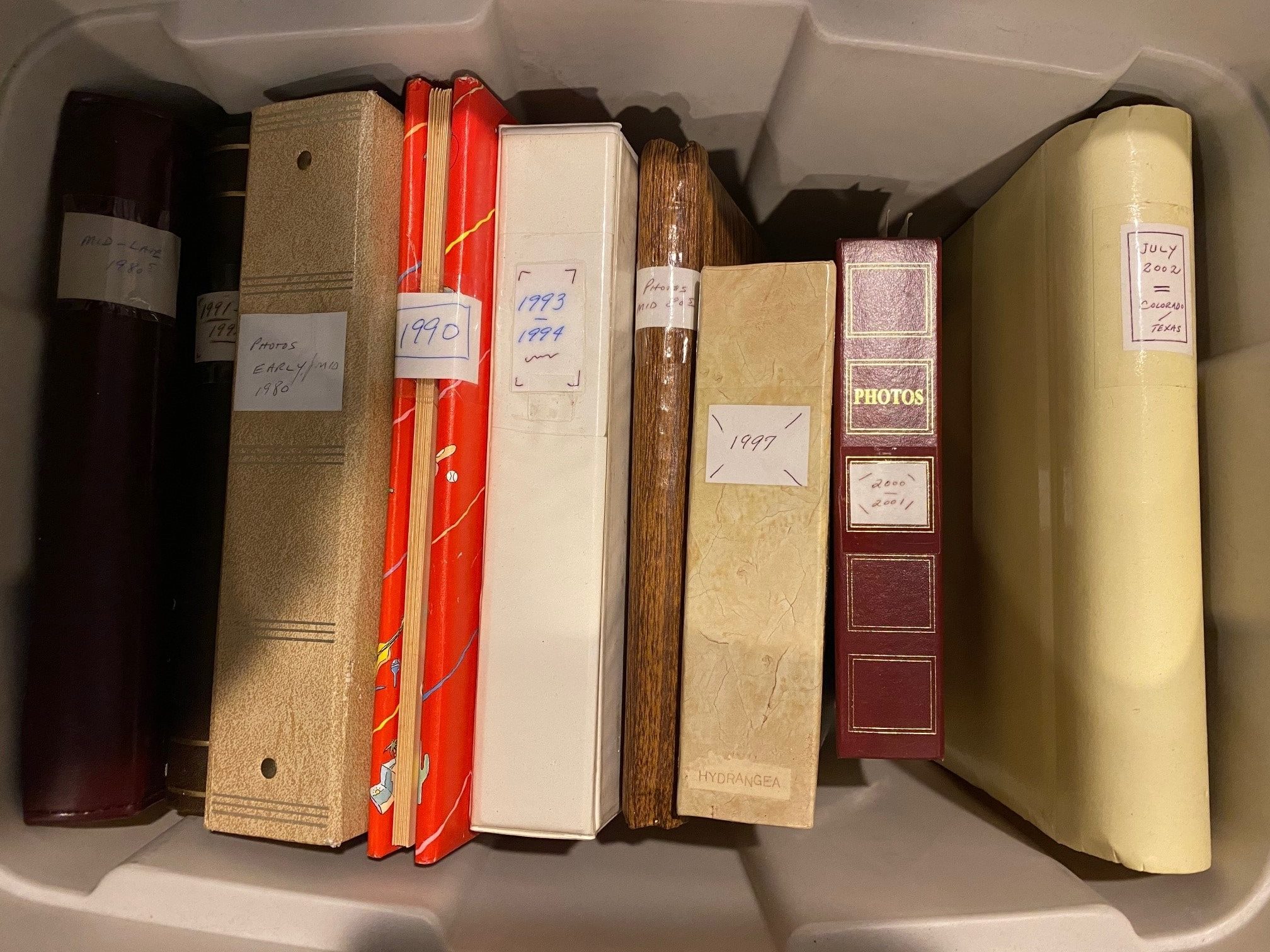 A vintage family photo album opened to a page of prints