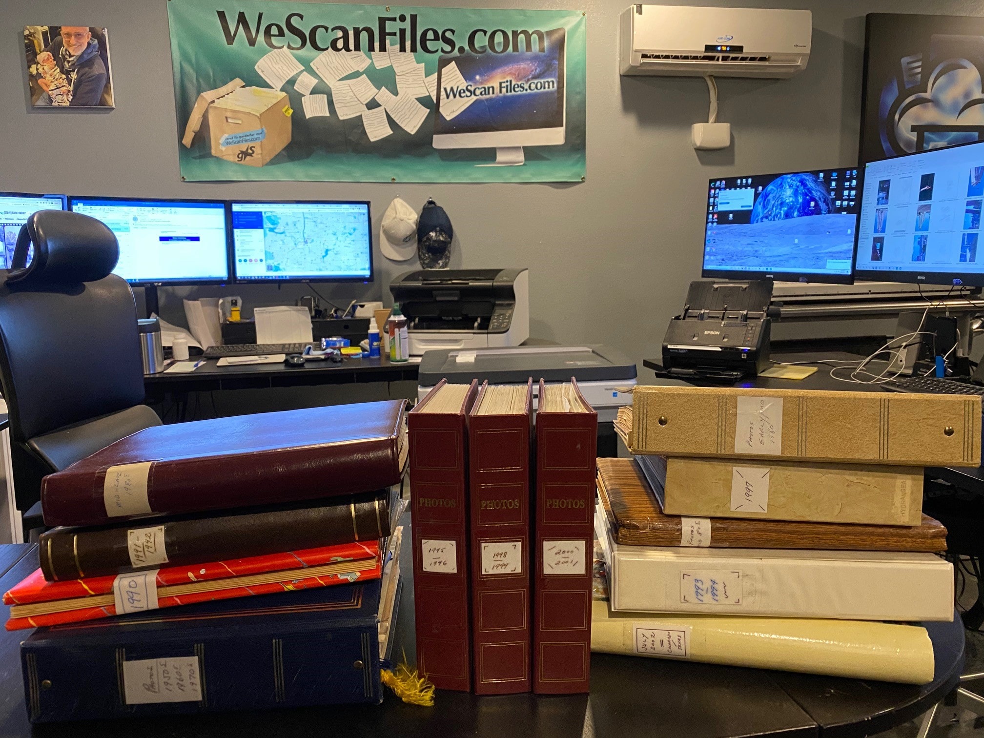 A stack of family photo albums ready for digitization