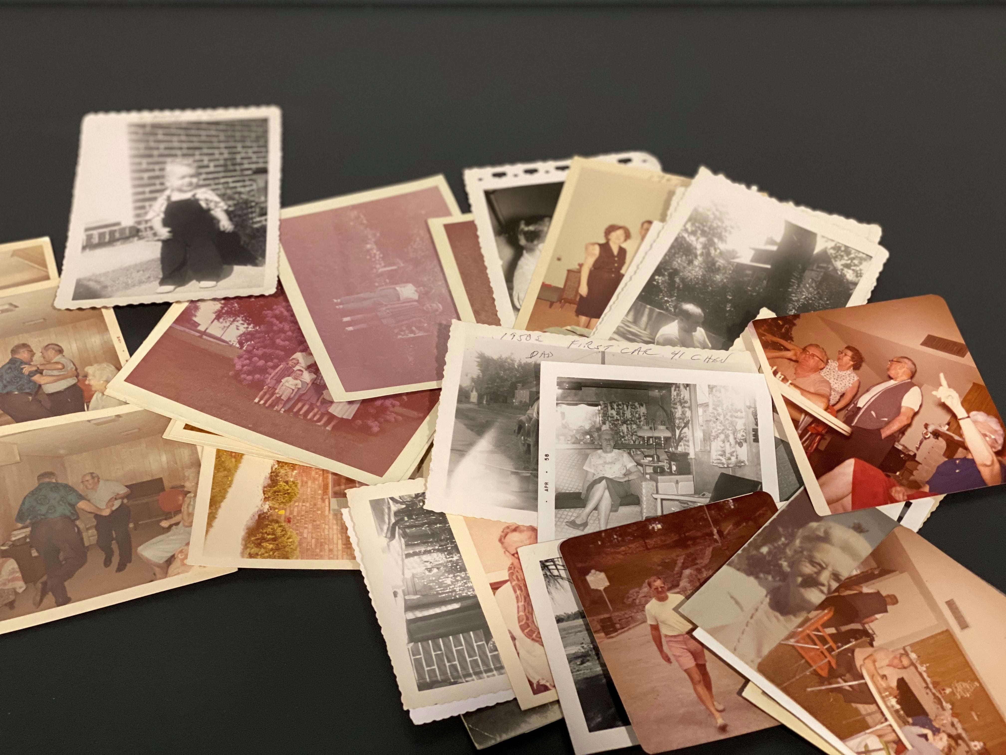 Stacks of loose family photographs waiting to be scanned